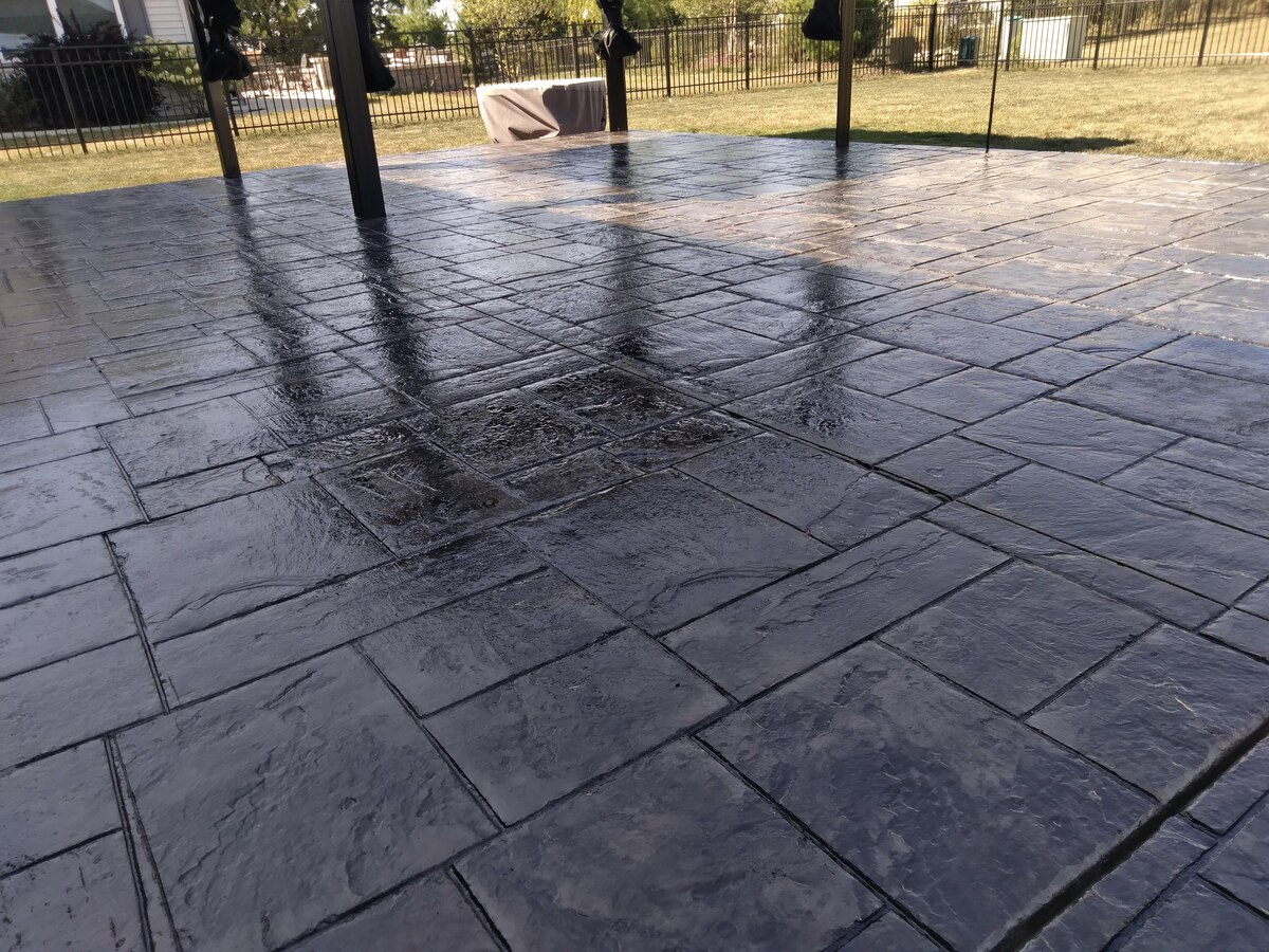 Close view of a dark stamped concrete patio